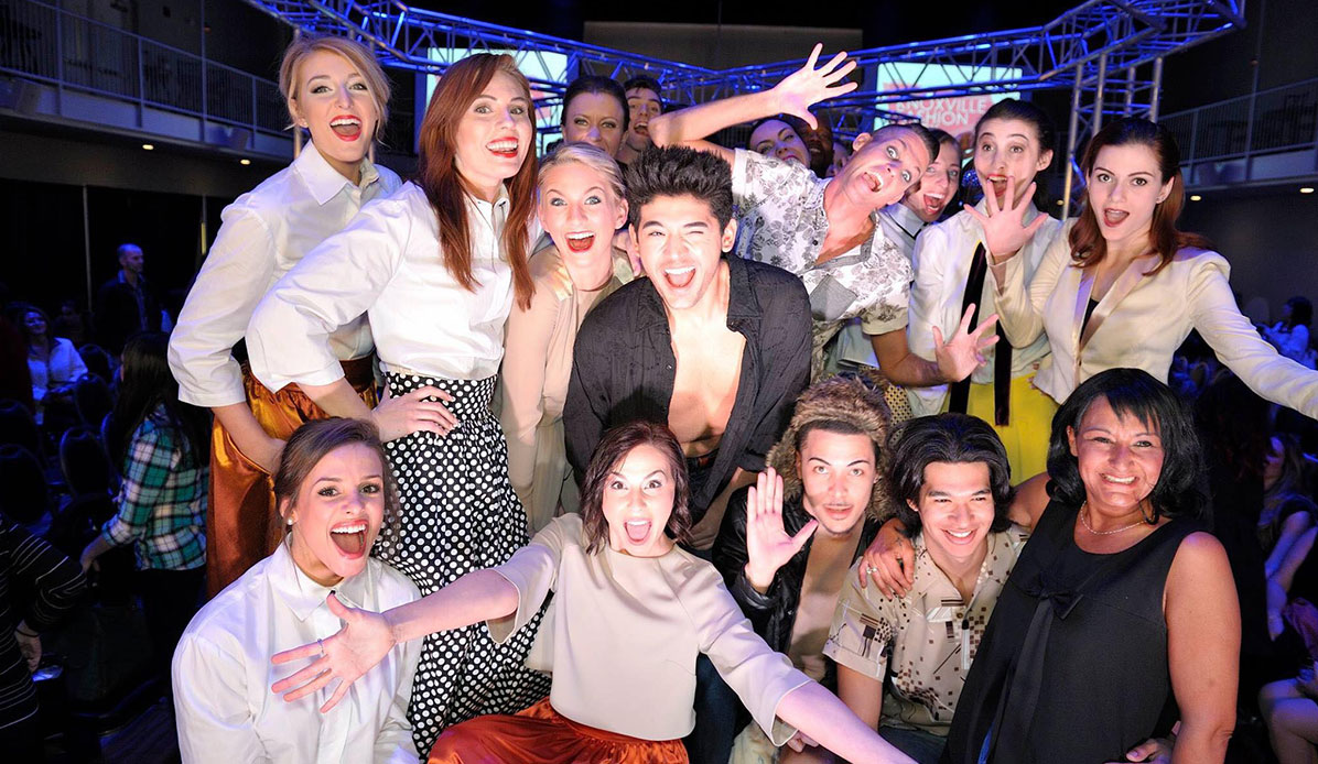 Models celebrate after a fashion show.