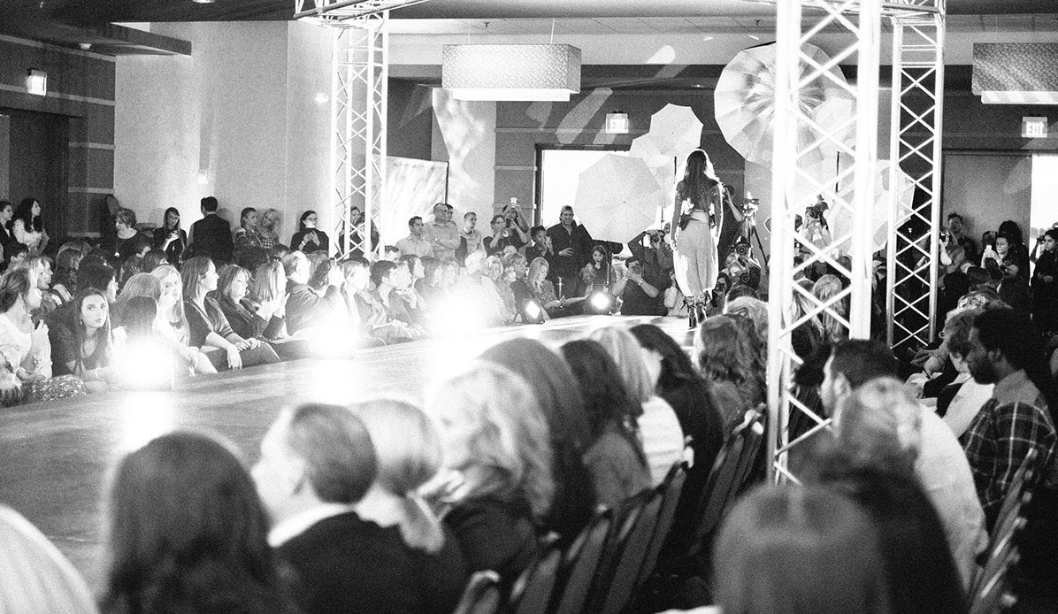 A black and white photo of a fashion show.