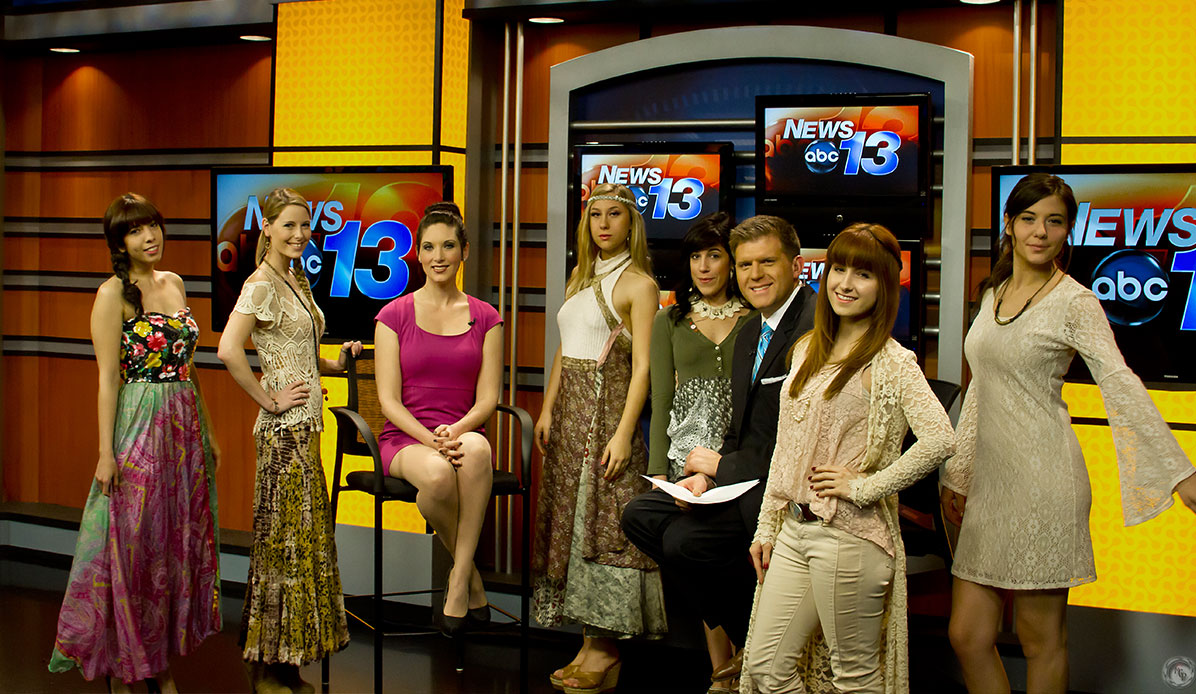 A group of models on a local news set.