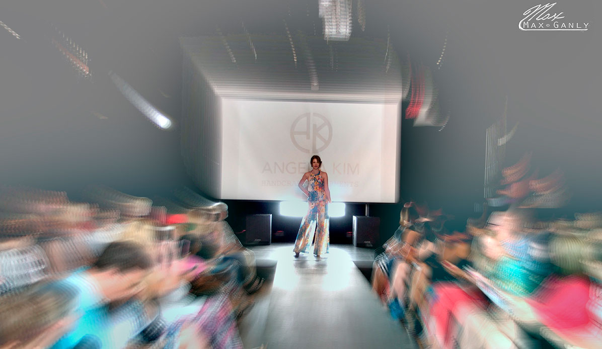 A blurred photo of a model in a fashion show.