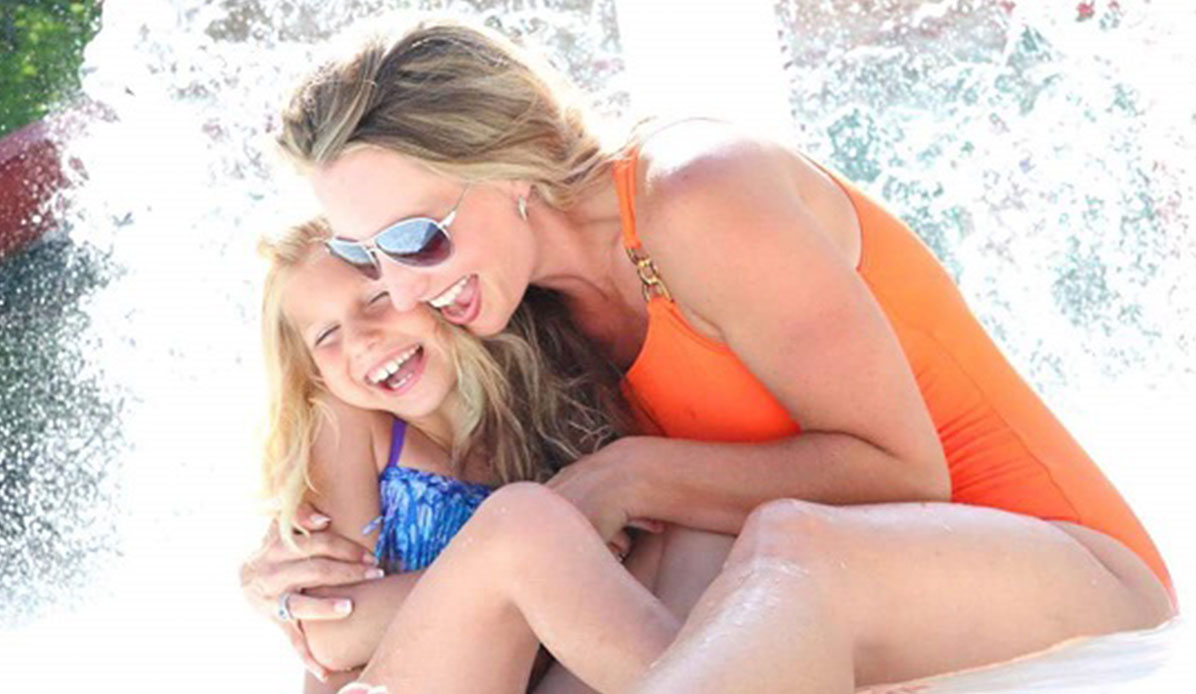 A woman and little girl model at a water park.